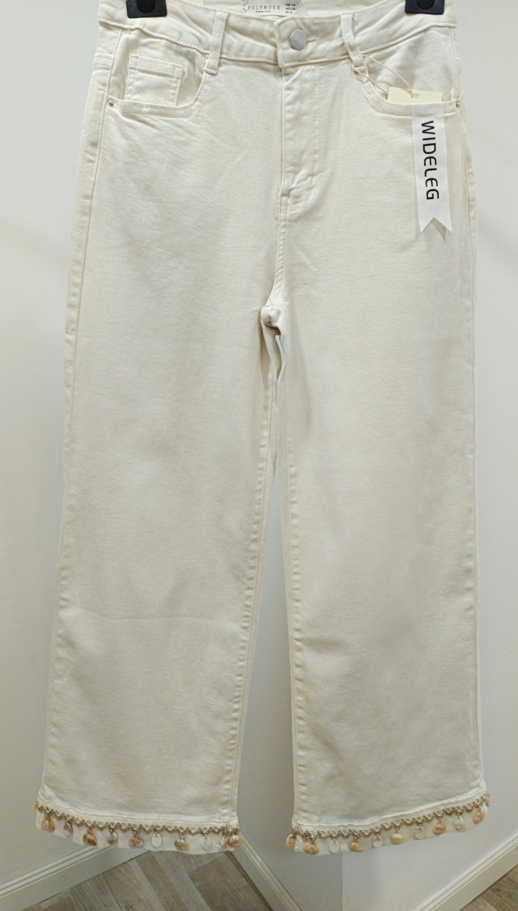 Jeans adorno conchas
